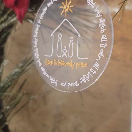 This is showing the ornament lighting so you can clearly see the metallic gold writing and clear nature of the ornament.